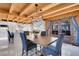 An elegant dining room with modern chandelier, wood accents, and access to the backyard at 10268 Christopher Dr, Conifer, CO 80433