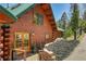 Charming log home exterior with a green metal roof and inviting wood-framed glass doors at 10268 Christopher Dr, Conifer, CO 80433