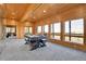 Spacious game room with a pool table and large windows offering scenic mountain views at 10268 Christopher Dr, Conifer, CO 80433