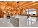 Open kitchen design features modern island, stainless appliances, and wood beamed ceilings at 10268 Christopher Dr, Conifer, CO 80433