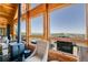 Cozy living room with a wood-burning stove and expansive windows showcasing mountain views at 10268 Christopher Dr, Conifer, CO 80433