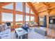 Cozy living room features wood beamed ceilings, fireplace, and ample seating for entertaining at 10268 Christopher Dr, Conifer, CO 80433