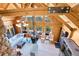 Bright living room with vaulted ceilings, wood beams, fireplace, and large windows at 10268 Christopher Dr, Conifer, CO 80433