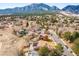 An aerial view of the house nestled in a vibrant community with majestic mountains in the background at 3380 Longwood Ave, Boulder, CO 80305