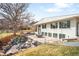 View of backyard patio with an outdoor kitchen, fire pit and lush landscaping at 3380 Longwood Ave, Boulder, CO 80305