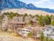 Panoramic view of neighborhood homes with the iconic Flatirons mountains in the background on a sunny day at 3380 Longwood Ave, Boulder, CO 80305