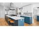 Stylish kitchen boasting custom cabinets, stainless steel appliances, and an island with barstool seating at 3380 Longwood Ave, Boulder, CO 80305