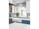 Close-up of kitchen featuring white countertops, gray backsplash, stainless faucet and farmhouse sink at 3380 Longwood Ave, Boulder, CO 80305