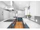 Modern kitchen with a gas range, stainless steel appliances, sleek countertops, and farmhouse sink at 3380 Longwood Ave, Boulder, CO 80305