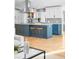 Modern kitchen with stainless steel appliances, gray backsplash, and a large island with seating for two at 3380 Longwood Ave, Boulder, CO 80305