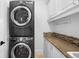 Convenient laundry room setup with stacked washer and dryer and countertop at 3380 Longwood Ave, Boulder, CO 80305
