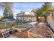 Large backyard with a covered patio, garden beds, and lush lawn at 6431 W Arbor Ave, Littleton, CO 80123