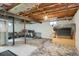 This basement has a support beam and exposed ceiling with a painted floor and white walls at 6431 W Arbor Ave, Littleton, CO 80123