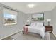 Well-lit bedroom features neutral colors, plush carpet, and window with a picturesque view at 6431 W Arbor Ave, Littleton, CO 80123