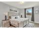 Serene bedroom with a plush bed, decorative accents, and a bright window view at 6431 W Arbor Ave, Littleton, CO 80123