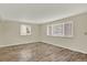 Bright bedroom featuring hardwood floors, lots of light, and neutral paint at 6431 W Arbor Ave, Littleton, CO 80123