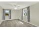 Comfortable bedroom featuring soft carpet, neutral walls, and bright windows at 6431 W Arbor Ave, Littleton, CO 80123