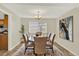 Elegant dining room with a round table, chandelier, and stylish decor at 6431 W Arbor Ave, Littleton, CO 80123