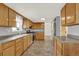 Functional kitchen featuring wooden cabinets, stainless steel appliances, and ample counter space at 6431 W Arbor Ave, Littleton, CO 80123