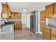 Functional kitchen featuring wooden cabinets, stainless steel appliances, and vinyl flooring at 6431 W Arbor Ave, Littleton, CO 80123