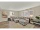 Bright living room featuring a comfortable sectional sofa and large windows at 6431 W Arbor Ave, Littleton, CO 80123