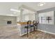 Open-concept living room with hardwood floors, fireplace, and breakfast bar area with seating at 6431 W Arbor Ave, Littleton, CO 80123