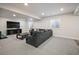 Spacious finished basement perfect for entertaining, featuring plush carpeting, cozy seating, and natural light at 5736 Cadara Way, Parker, CO 80134