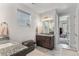 Bathroom featuring granite countertops, double sinks, and a walk-in shower at 5736 Cadara Way, Parker, CO 80134