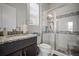 Modern bathroom showcases glass shower, granite vanity, and bright natural light for a spa-like experience at 5736 Cadara Way, Parker, CO 80134