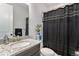Bathroom featuring a vanity with granite countertop, a mirror, and a shower with black curtain at 5736 Cadara Way, Parker, CO 80134