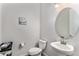 Powder room featuring a pedestal sink, toilet, and minimalist artwork at 5736 Cadara Way, Parker, CO 80134