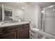 Modern bathroom with granite countertop, glass-enclosed shower and updated fixtures at 5736 Cadara Way, Parker, CO 80134