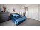 Comfortable bedroom features plush bedding, dresser and mirror, creating a serene and inviting space at 5736 Cadara Way, Parker, CO 80134