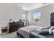 Neutral bedroom with a dresser, mirror, and two windows providing natural light and neighborhood views at 5736 Cadara Way, Parker, CO 80134