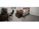 Cozy bedroom with a wooden bed frame, work desk, and carpeted floor at 5736 Cadara Way, Parker, CO 80134