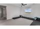 Bright, spacious room with carpet, black couches, throw pillows, and a view to the outside at 5736 Cadara Way, Parker, CO 80134