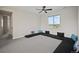 Versatile bonus room with comfortable floor seating, neutral carpet, and a large window with neighborhood views at 5736 Cadara Way, Parker, CO 80134