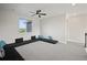 Bright bonus room features a modern ceiling fan, neutral decor, and unique built-in lounge area at 5736 Cadara Way, Parker, CO 80134