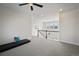 Open bonus room with a view of dining area, neutral carpeting, and white railing at 5736 Cadara Way, Parker, CO 80134