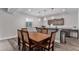 Dining room area with a large wooden table, chandelier lighting, and wood floors at 5736 Cadara Way, Parker, CO 80134