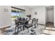 Elegant dining room featuring a stylish table set, contemporary decor, and sliding glass doors to the backyard at 5736 Cadara Way, Parker, CO 80134