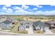 Beautiful two-story home with gray siding, a well-manicured lawn, and a stunning mountain view in the background at 5736 Cadara Way, Parker, CO 80134