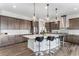 Well-lit kitchen with a large center island, seating, stainless steel appliances, and beautiful cabinetry at 5736 Cadara Way, Parker, CO 80134