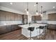 Gourmet kitchen featuring a large center island, pendant lighting, and ample cabinet space at 5736 Cadara Way, Parker, CO 80134