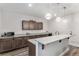 Kitchenette featuring granite countertops, wooden cabinets, pendant lights, and stainless steel appliances at 5736 Cadara Way, Parker, CO 80134