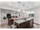 Eat-in kitchen with island, granite countertops, stainless steel appliances, wood floors and dining table at 5736 Cadara Way, Parker, CO 80134