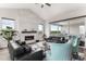 Bright living room boasts a fireplace, comfortable seating, large windows, and access to the backyard at 5736 Cadara Way, Parker, CO 80134