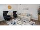 Cozy living room features stylish seating, a glass table, and a patterned rug at 5736 Cadara Way, Parker, CO 80134