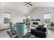Inviting living room featuring a modern fireplace, comfortable sofas, stylish decor, and lots of natural light at 5736 Cadara Way, Parker, CO 80134