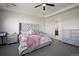 Main bedroom features stylish bed, tray ceiling, and ensuite bathroom at 5736 Cadara Way, Parker, CO 80134